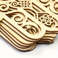 Wooden decorative elements with intricate carvings on a white background