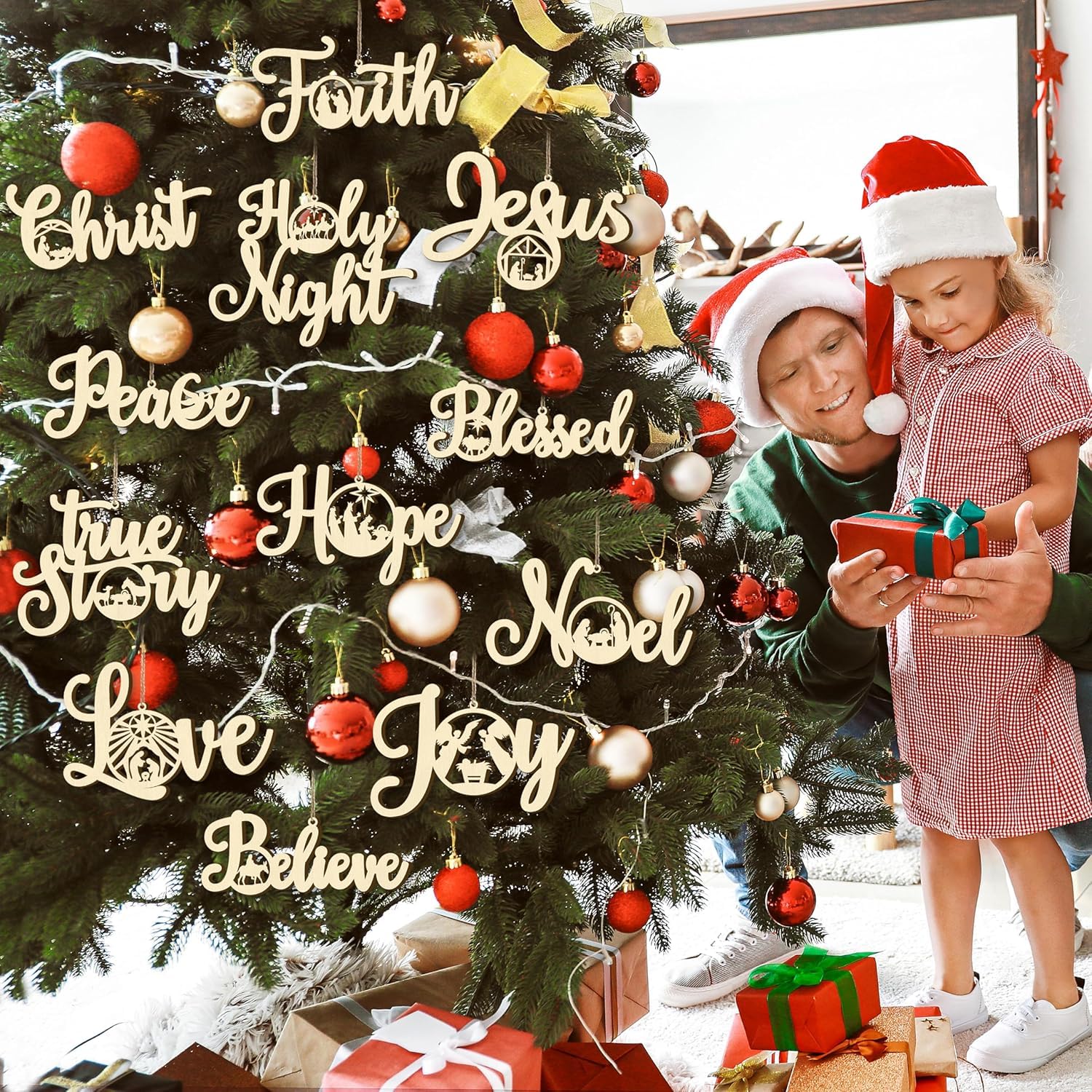 Two children in front of a Christmas tree with decorative words and ornaments.