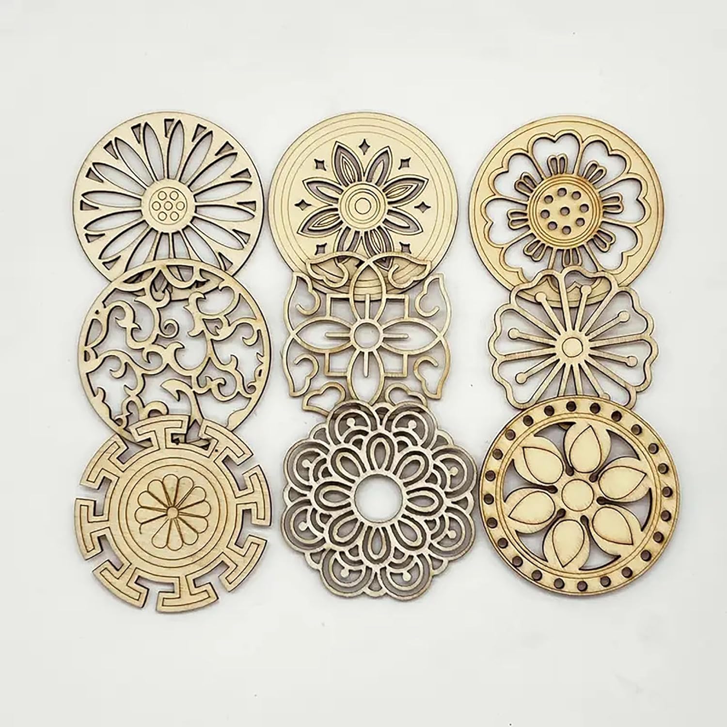 Set of gold and silver floral-patterned metal components on a white background