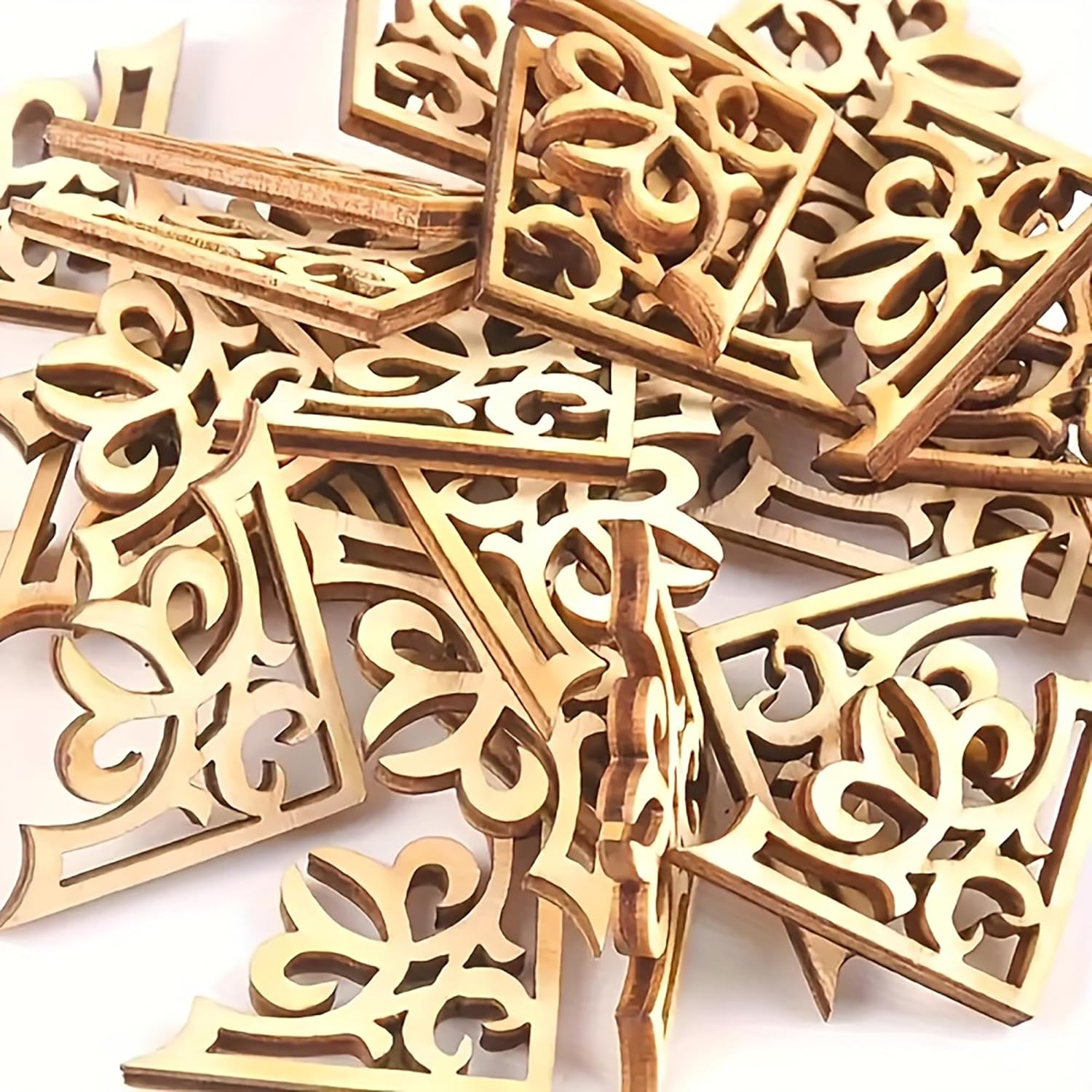 Wooden decorative pieces with intricate carvings on a white background