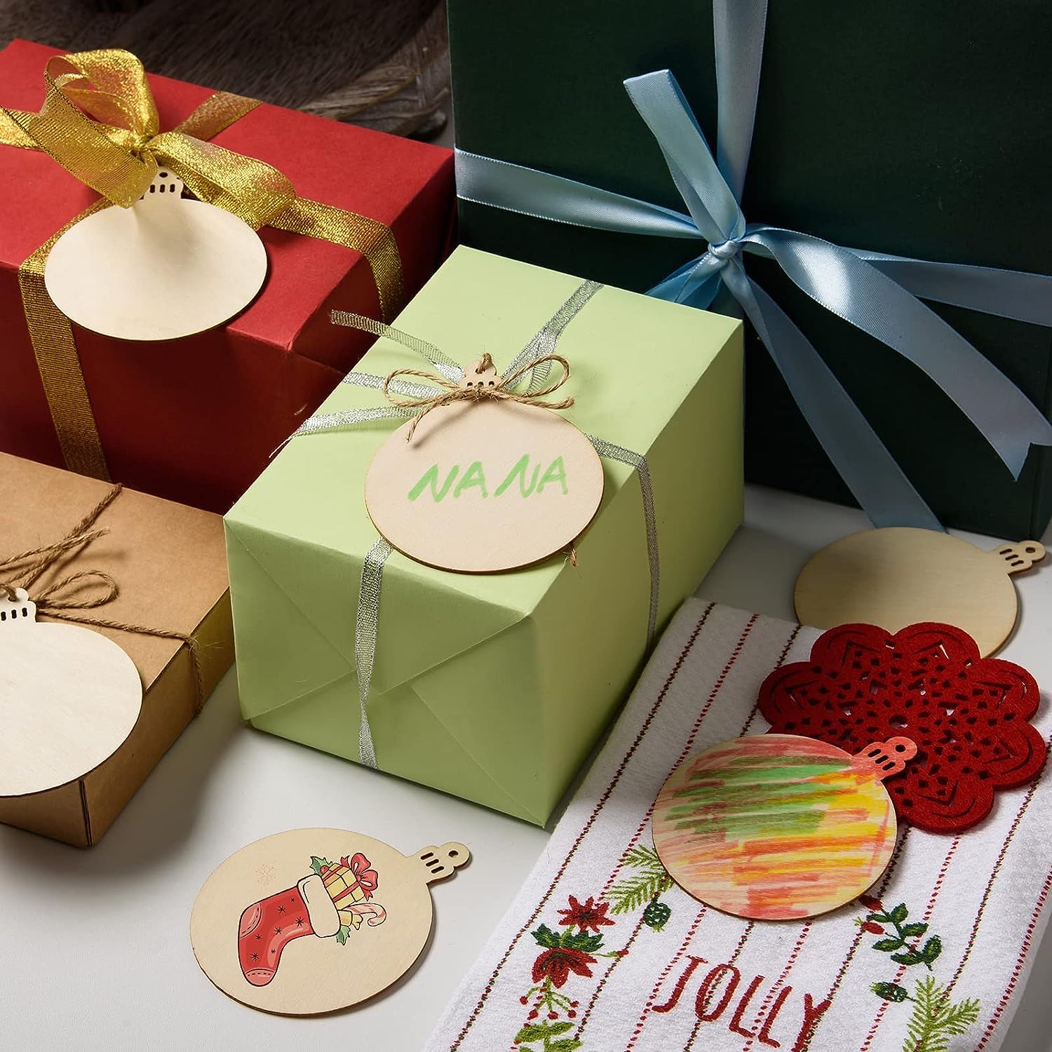 Green gift box with 'Nana' tag, surrounded by Christmas-themed decorations and ribbons.