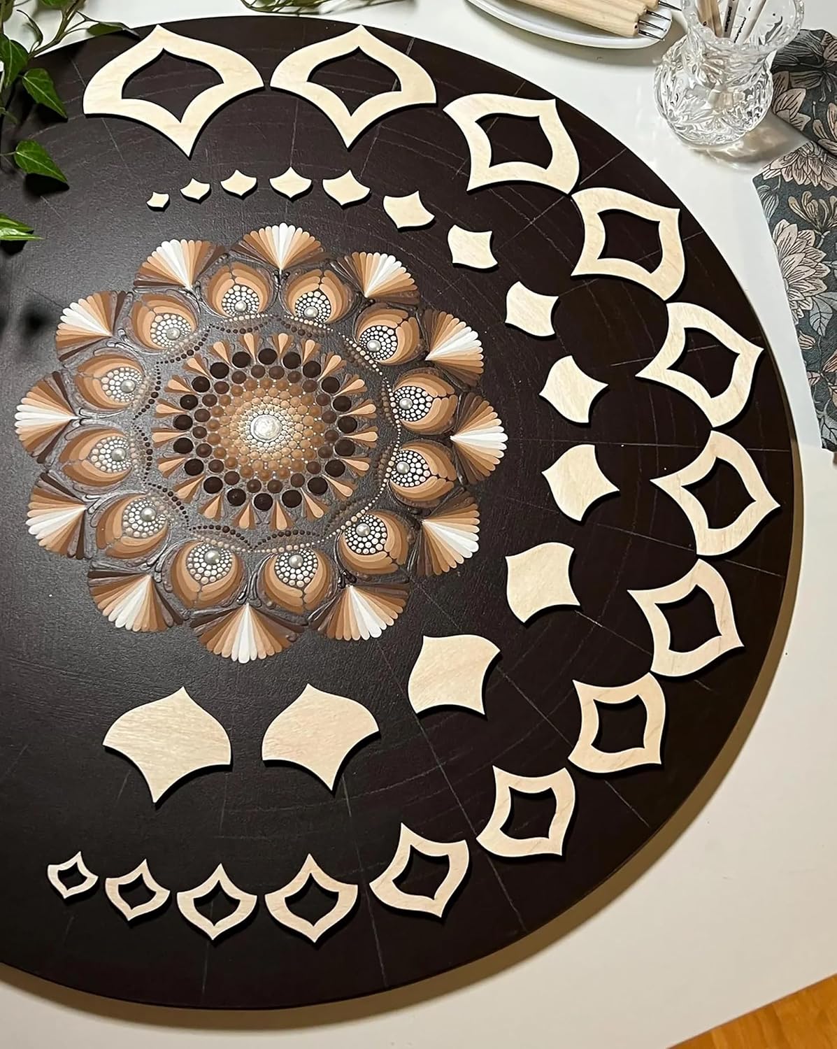 Decorative round table with intricate black and white pattern on a white surface