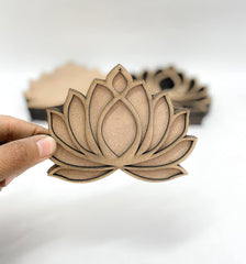 Hand holding a wooden lotus leaf-shaped object against a white background