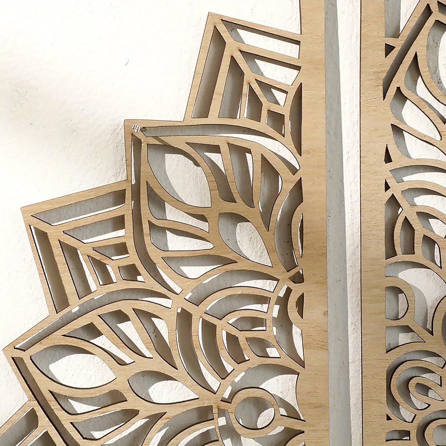 Wooden decorative panels with intricate cut-out patterns on a white background