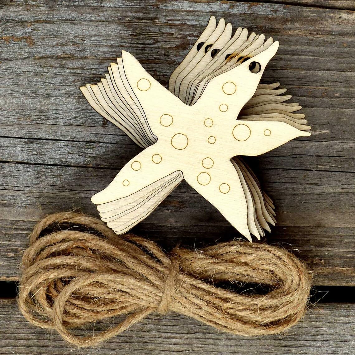 Wooden starfish ornament with twine on a wooden surface