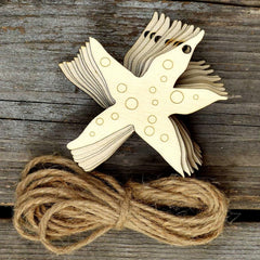 Wooden starfish ornament with twine on a wooden surface