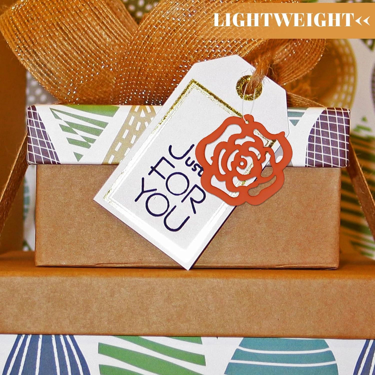 Gift box with decorative tag and rose design on a wooden surface