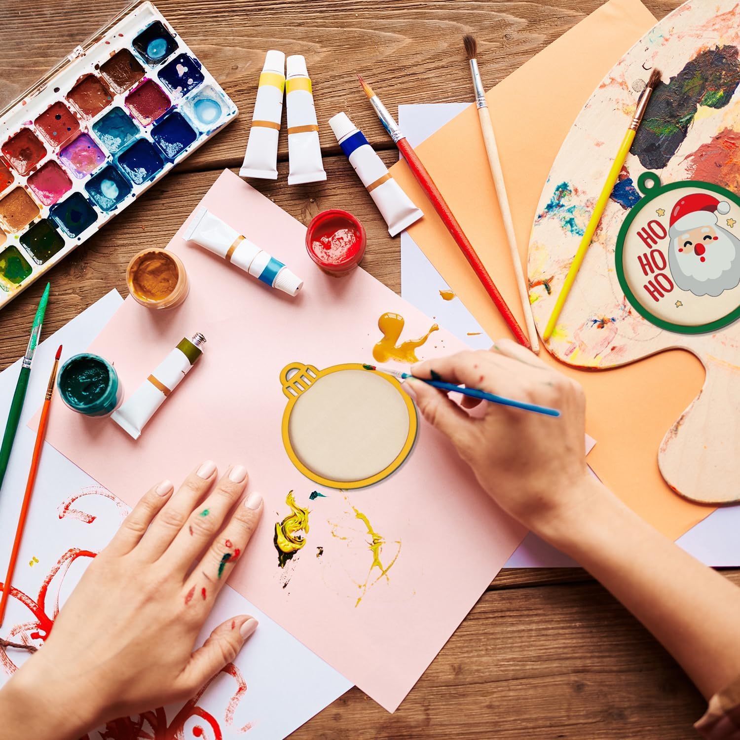 Artistic activity with paint supplies on a wooden table