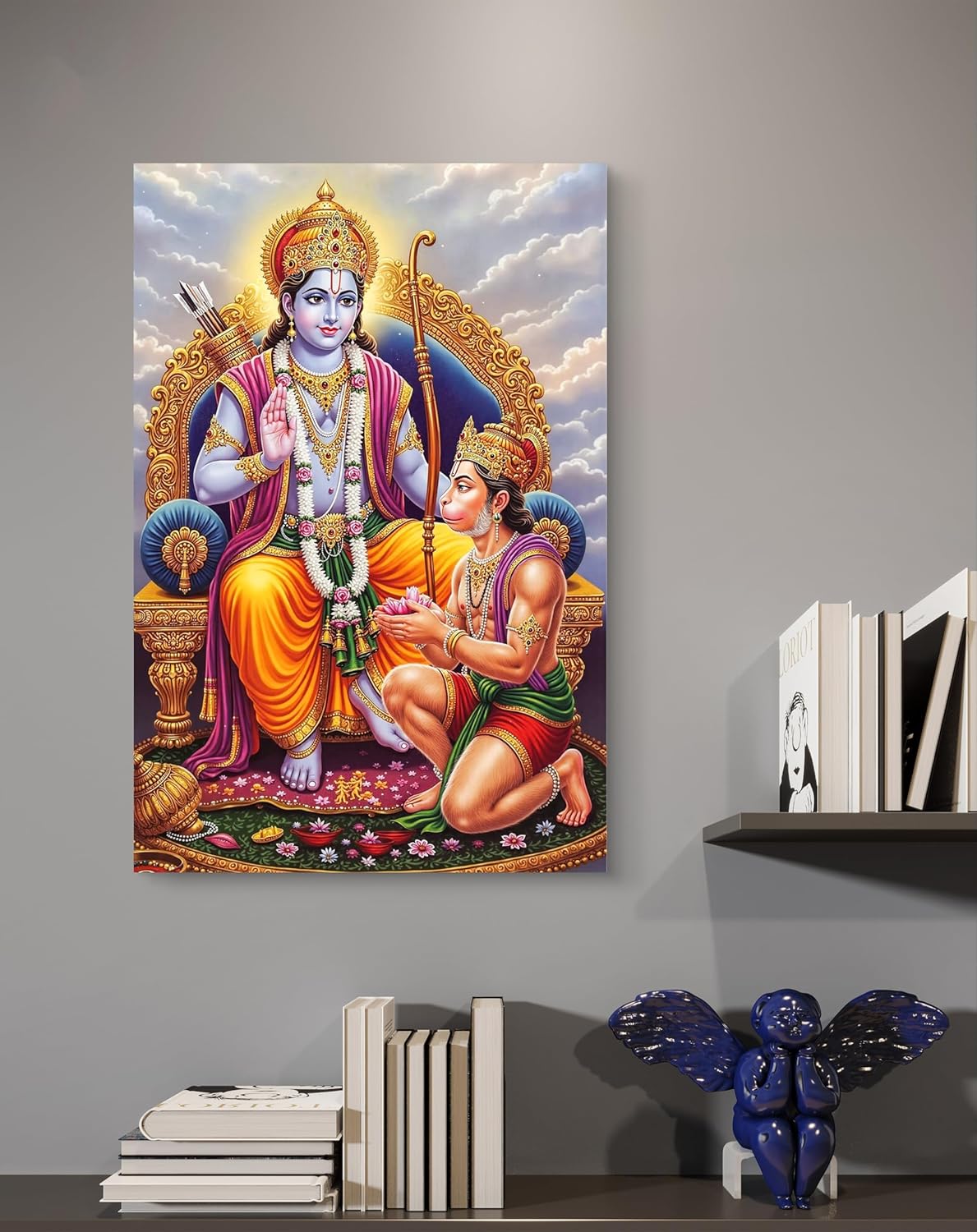 Canvas print of a religious scene with two figures on a gray wall, below books and decorative items.