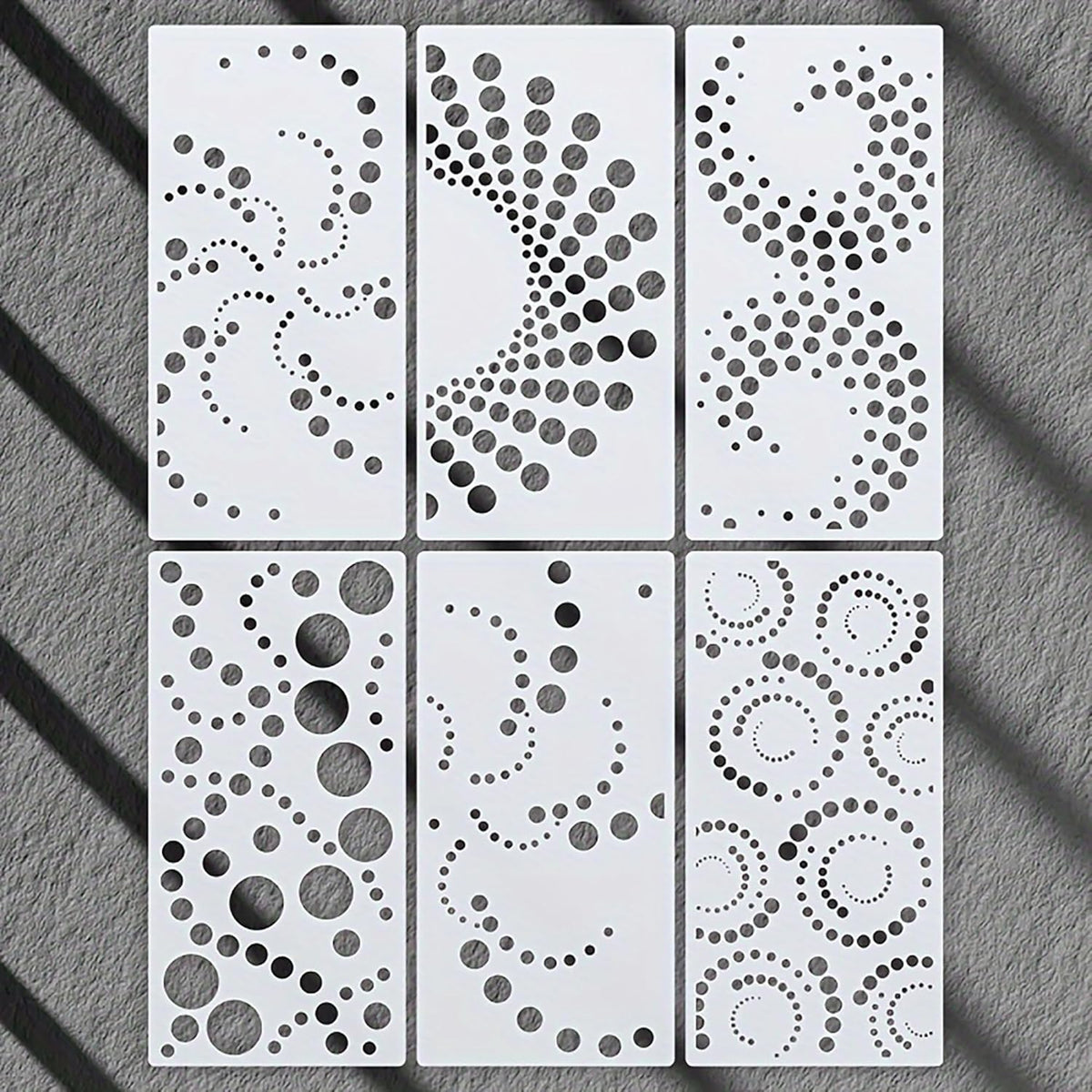Six decorative panels with geometric patterns on a gray surface