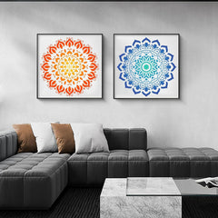 Two framed mandala artworks on a wall above a gray sectional sofa.