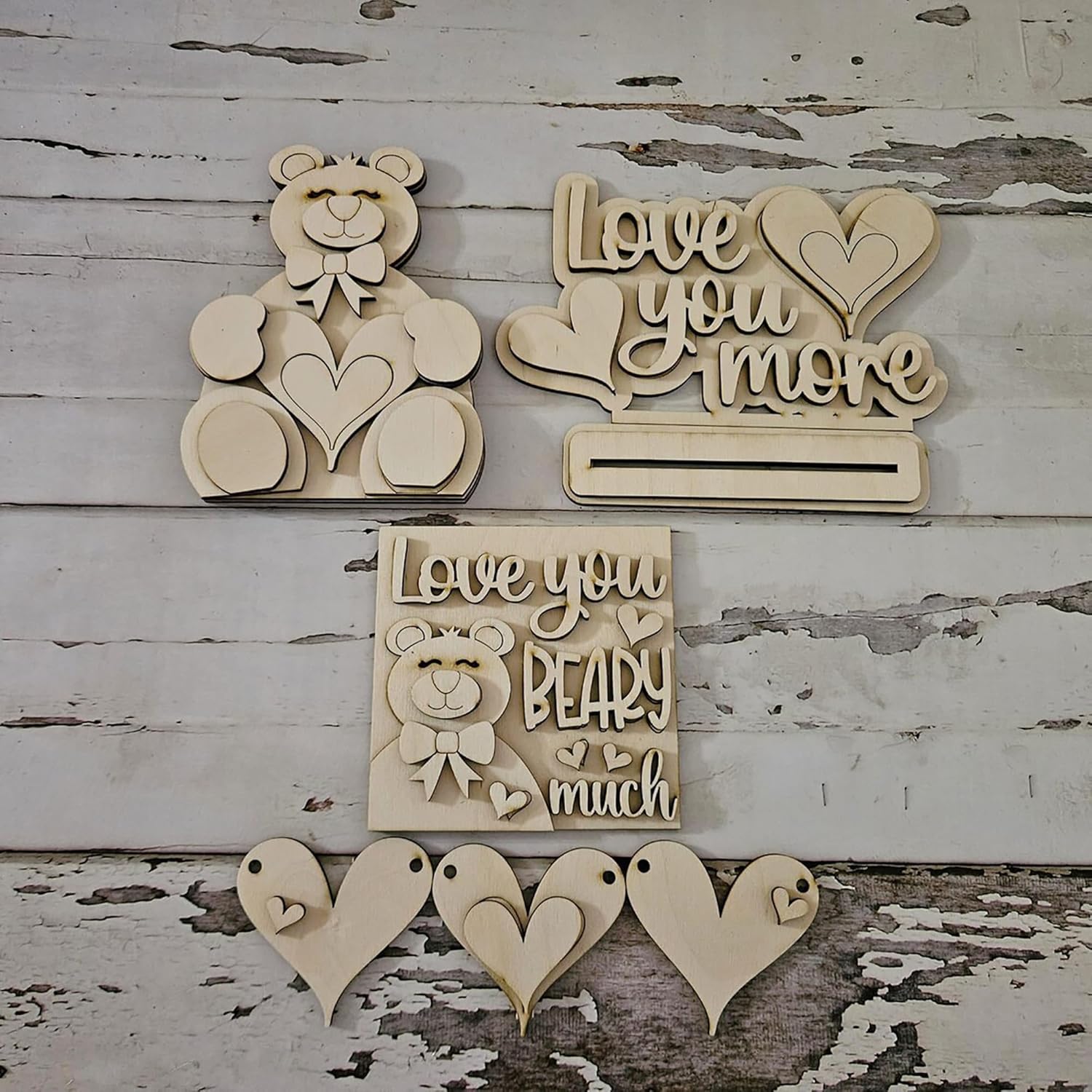 Wooden decorative signs with teddy bears and text on a rustic wooden background