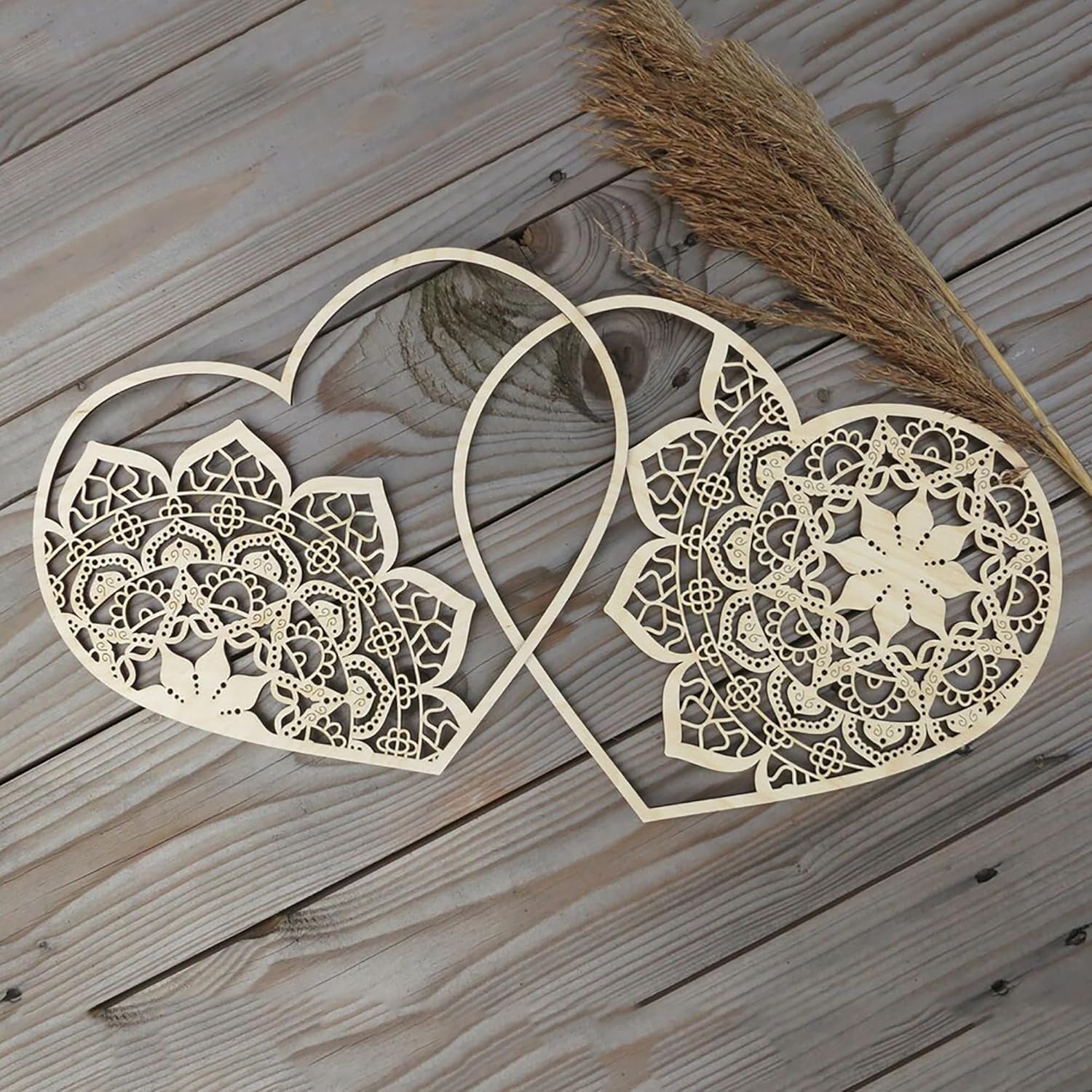 Decorative heart-shaped cutout with intricate patterns on a wooden surface