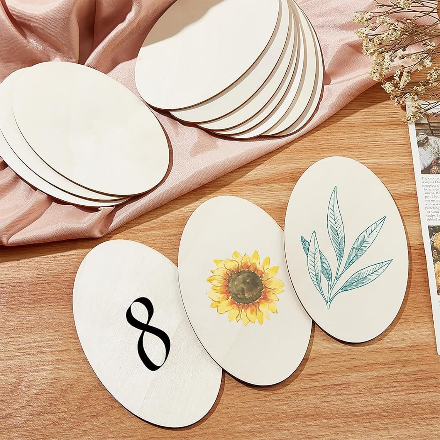 Round white cards with printed designs on a wooden surface