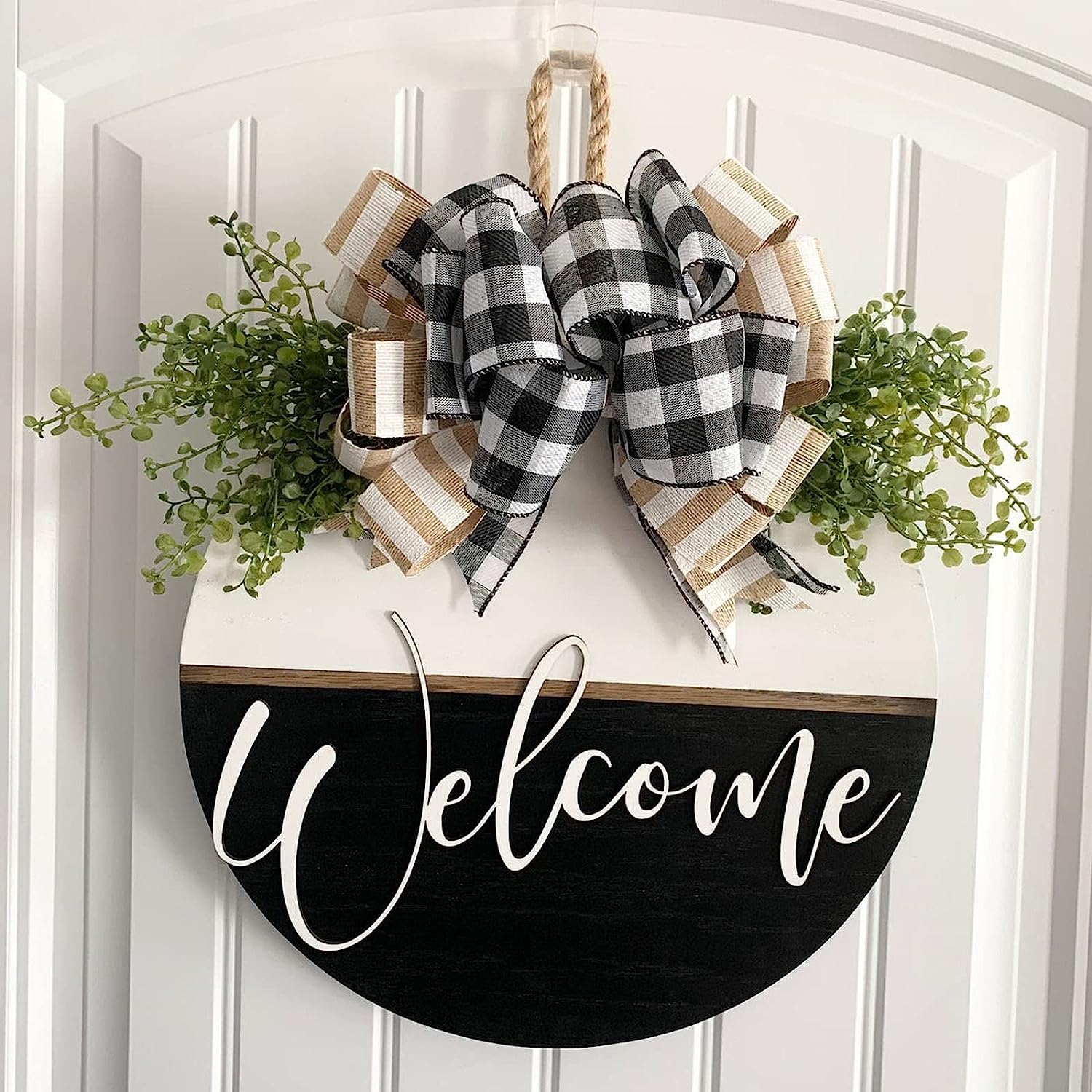 Decorative sign with a plaid bow and greenery on a white background