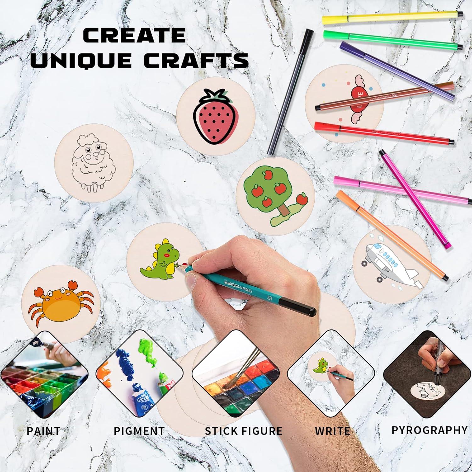 Set of wooden discs with pre-drawn designs, markers, and a hand painting on a marble surface.