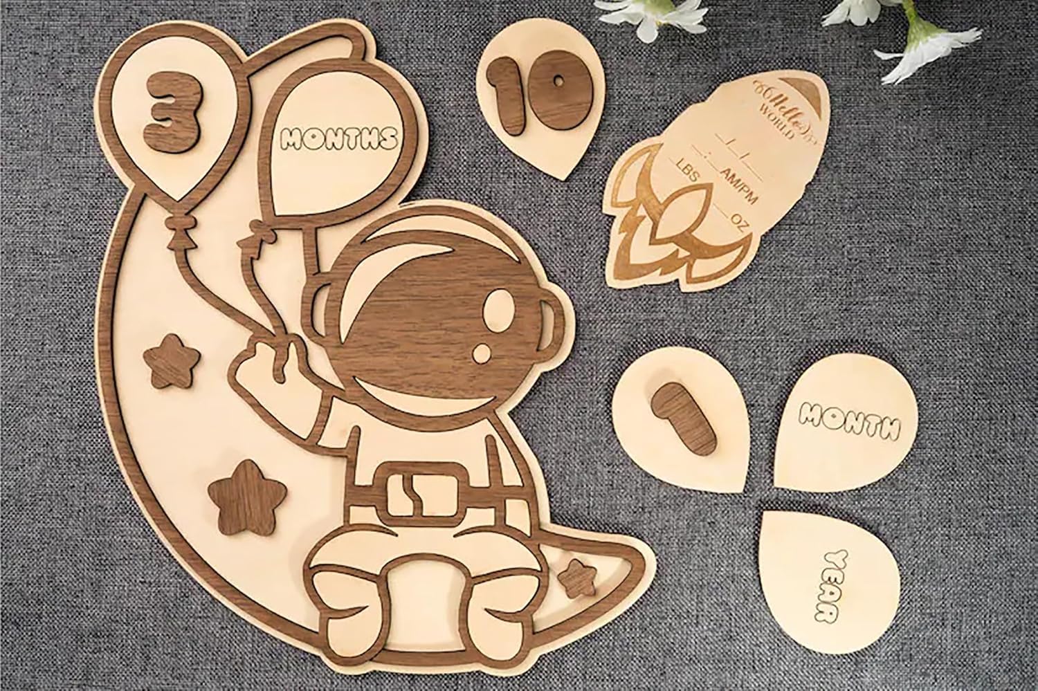 Wooden baby milestone cards with astronaut design and wooden pieces for months 3, 6, and 10.
