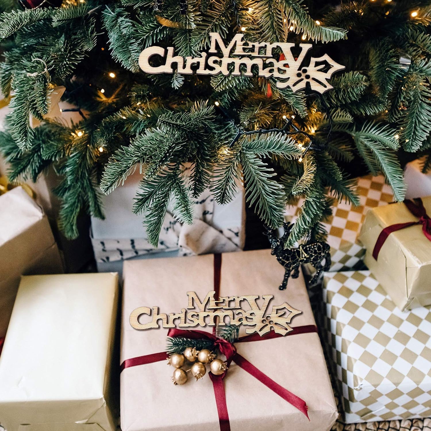 Decorated Christmas tree with wrapped gifts and 'Merry Christmas' ornaments.