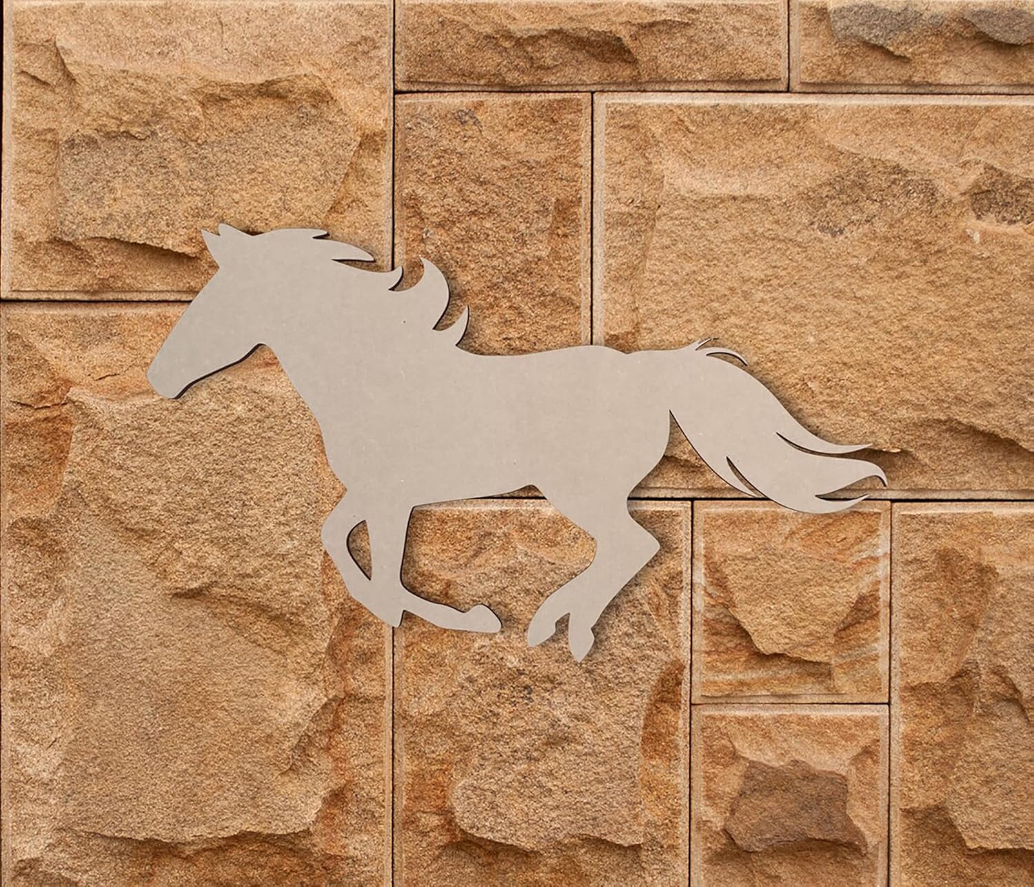 Silhouette of a horse on a stone wall