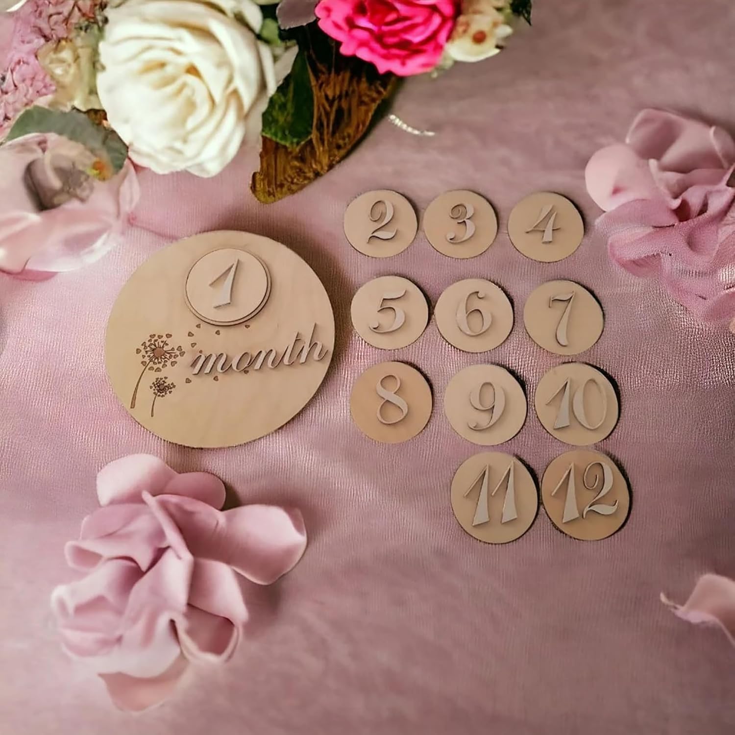 Wooden milestone cards with numbers on a pink background with flowers