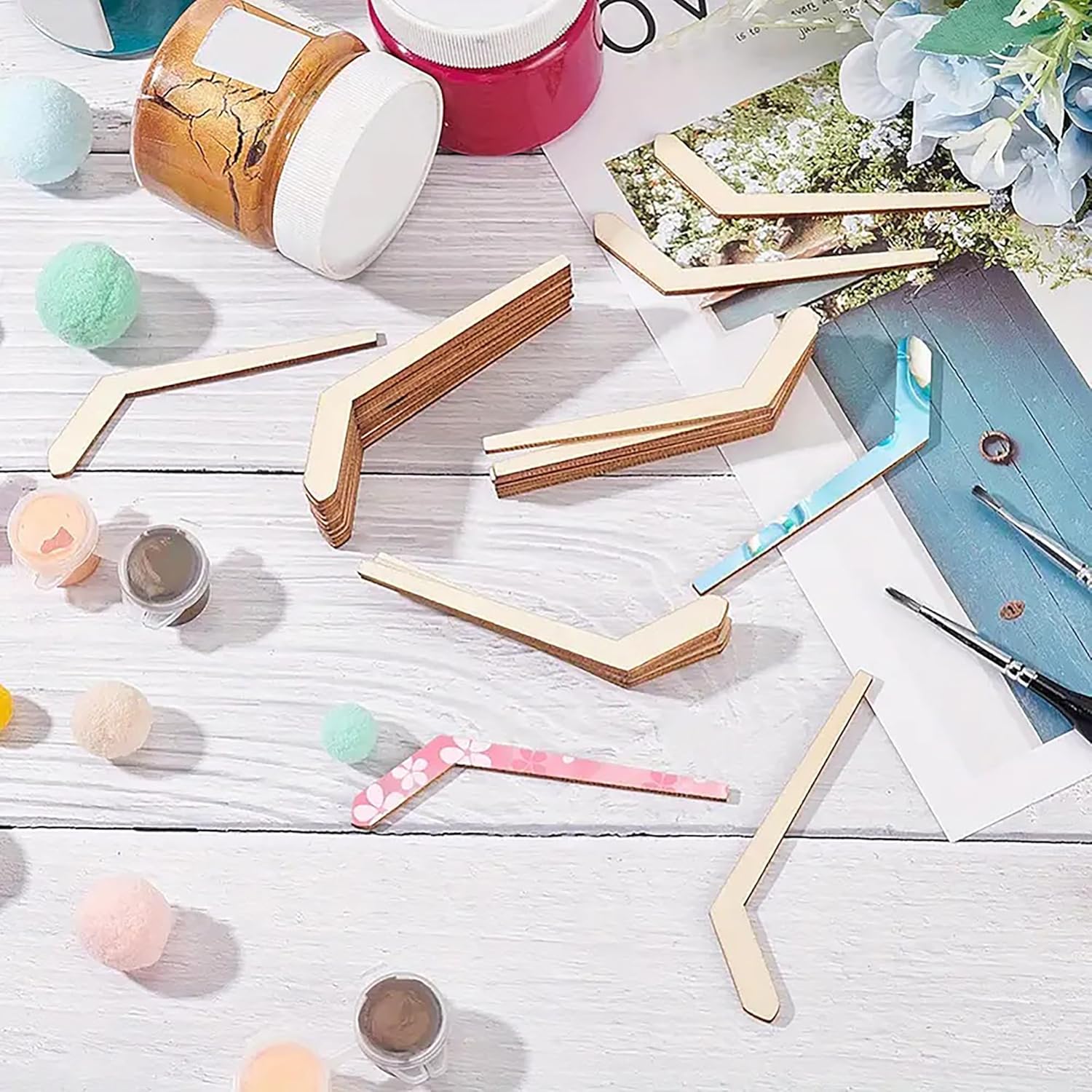 Wooden photo frames on a light wooden surface with decorative items.