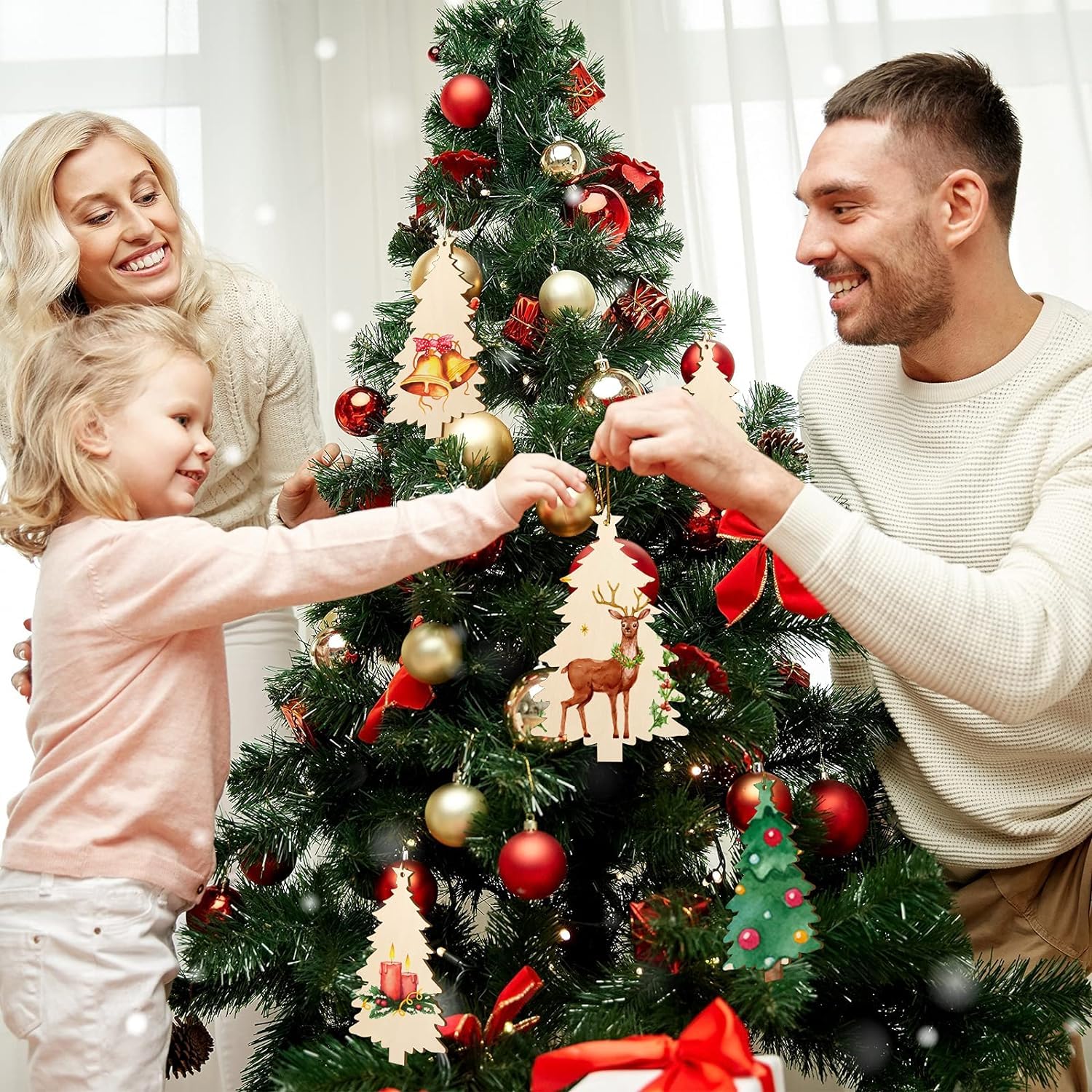 Family decorating a Christmas tree with ornaments and lights.