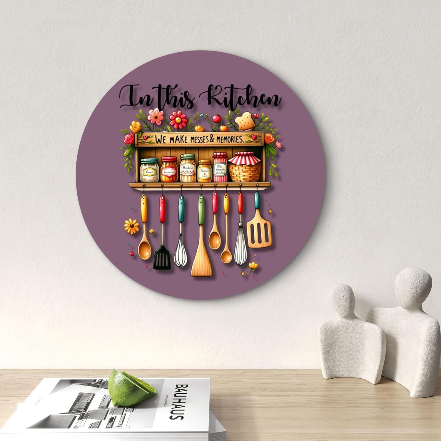 Decorative wall clock with kitchen-themed design on a white wall.