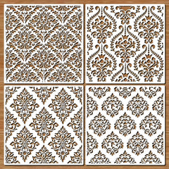 Four decorative panels with intricate patterns on a wooden background