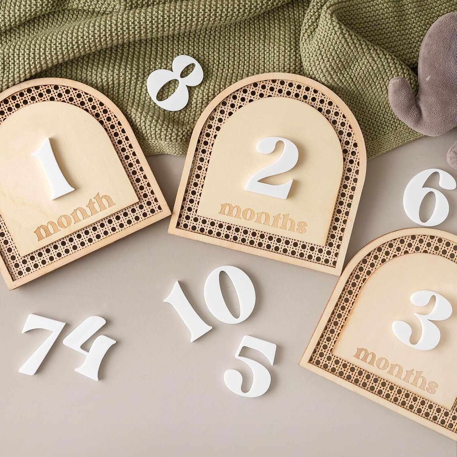 Baby milestone cards with numbers on a neutral background