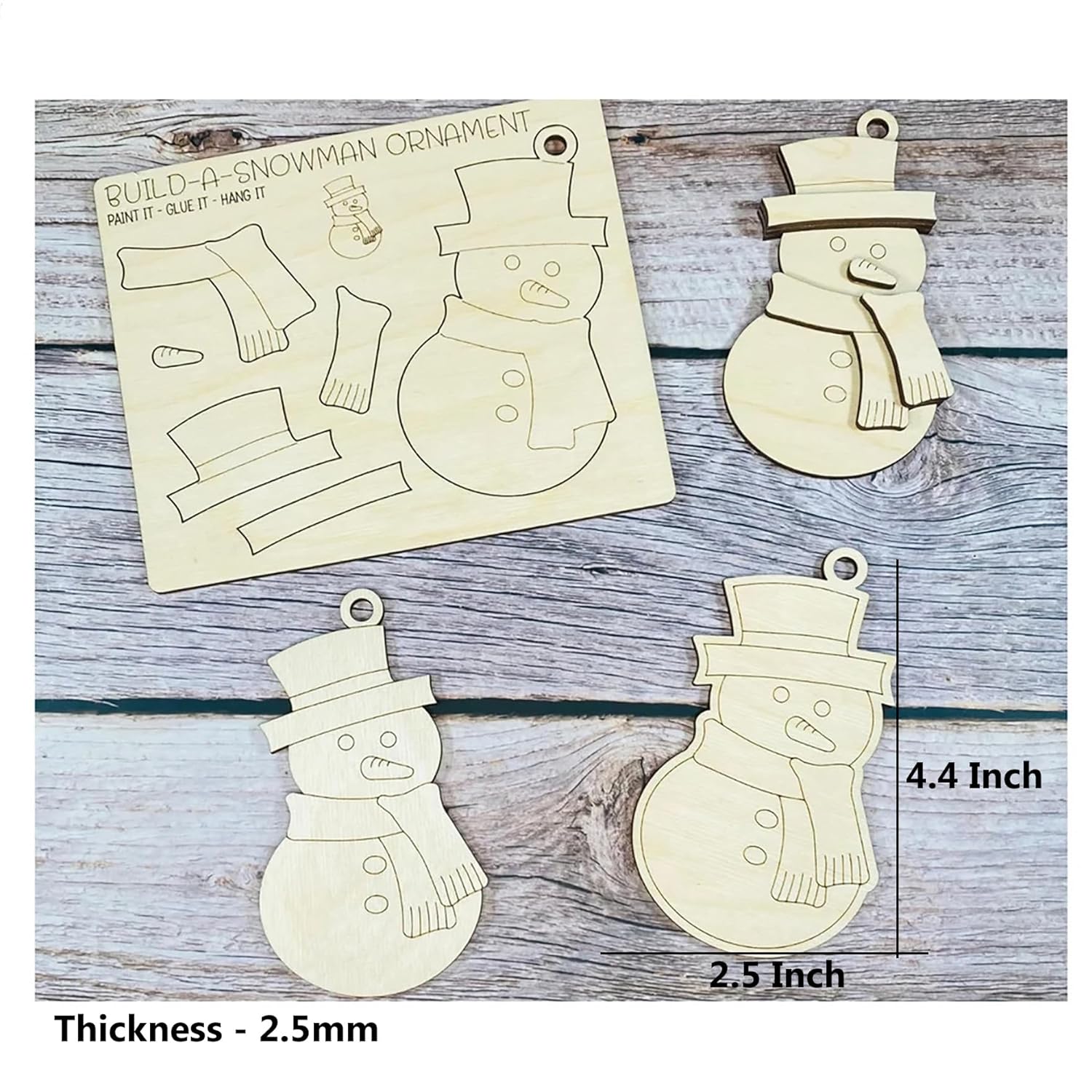 Wooden snowman ornament kit with pieces and an unassembled ornament on a wooden surface.