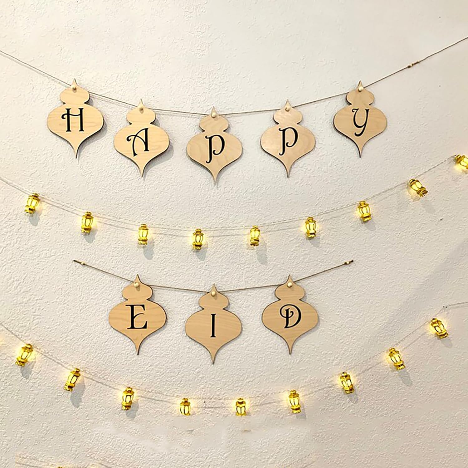 Decorative string banner with 'Happy Eid' on a light background
