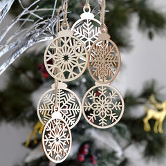 Decorative snowflake ornament hanging on a tree with a blurred background