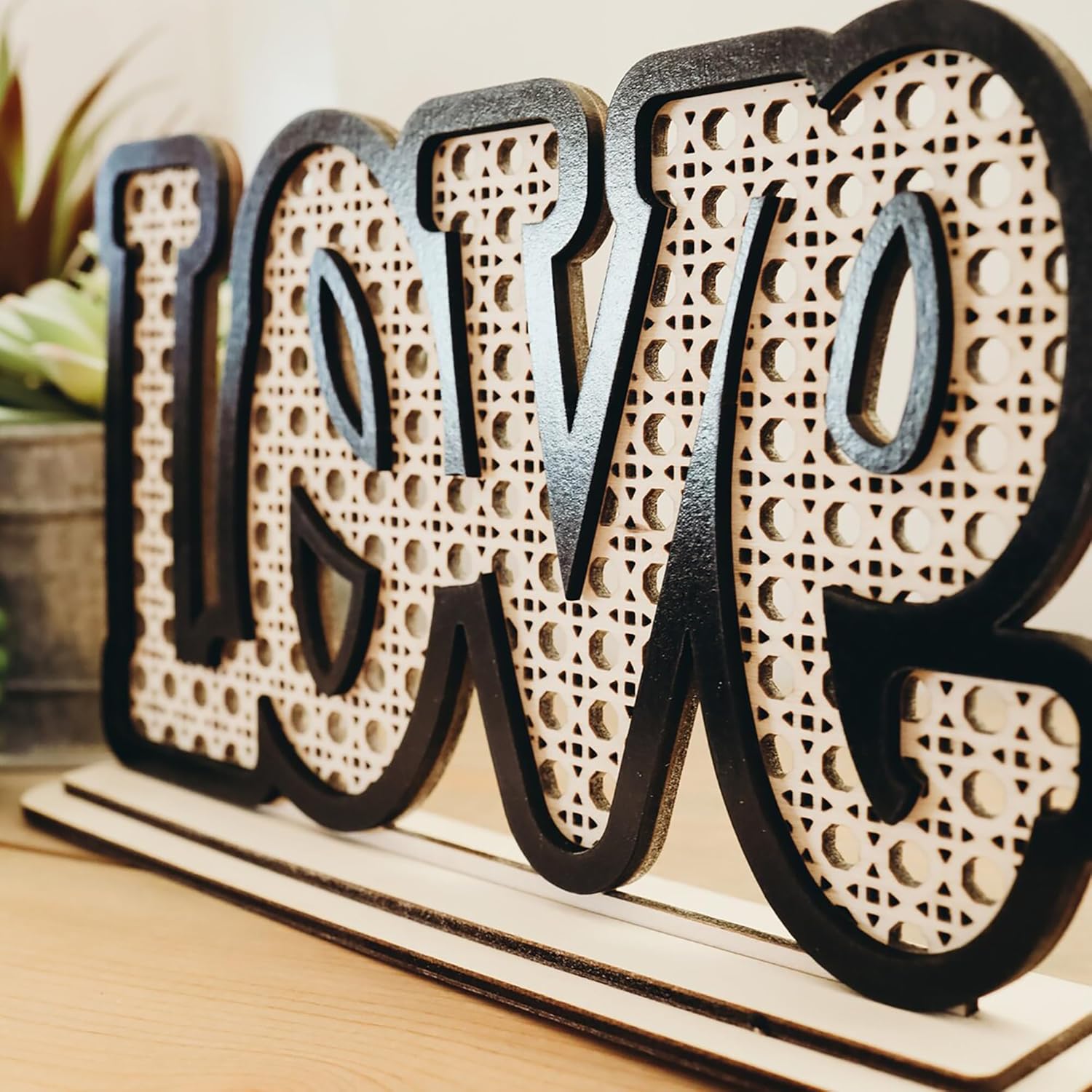Decorative wooden letters spelling 'LOVE' on a wooden base.