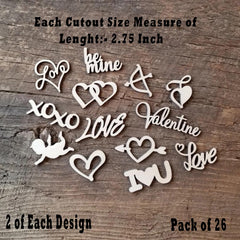 Wooden cutouts with love-themed designs on a wooden surface