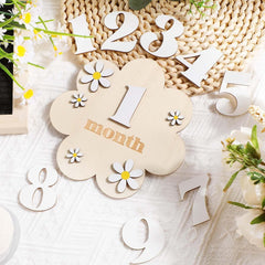 Wooden baby milestone card with '1 month' on a textured surface with flowers.
