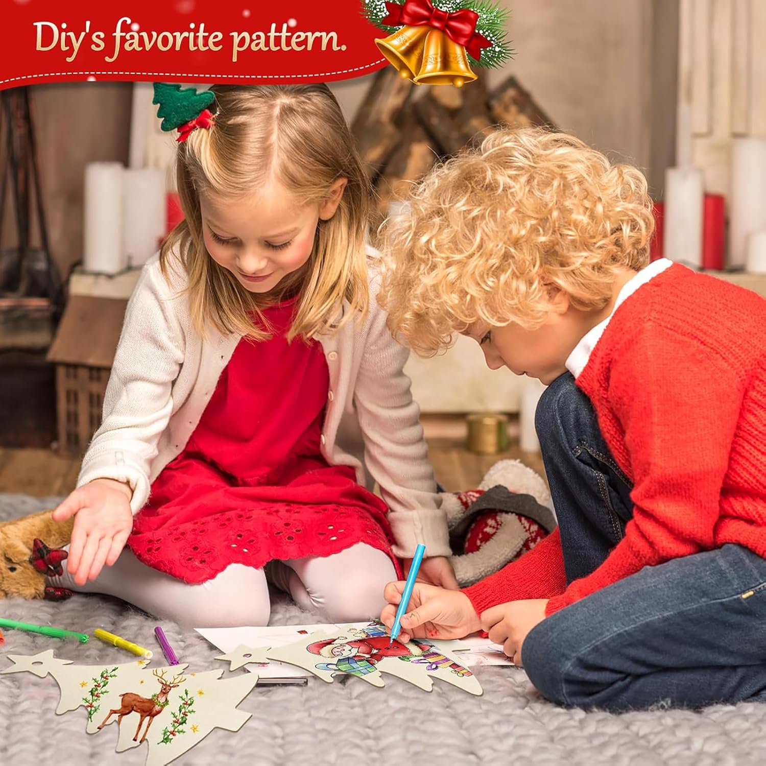 Two children sitting on a carpet, engaged in a craft activity with Christmas-themed paper cutouts.