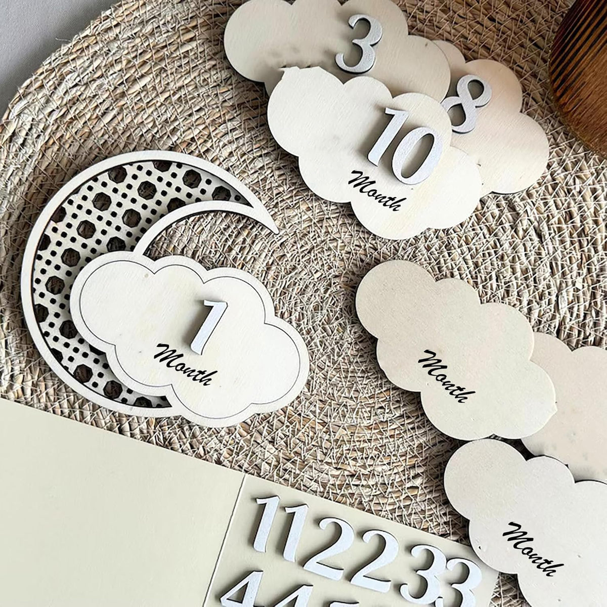 Baby milestone cards with numbers on a textured surface