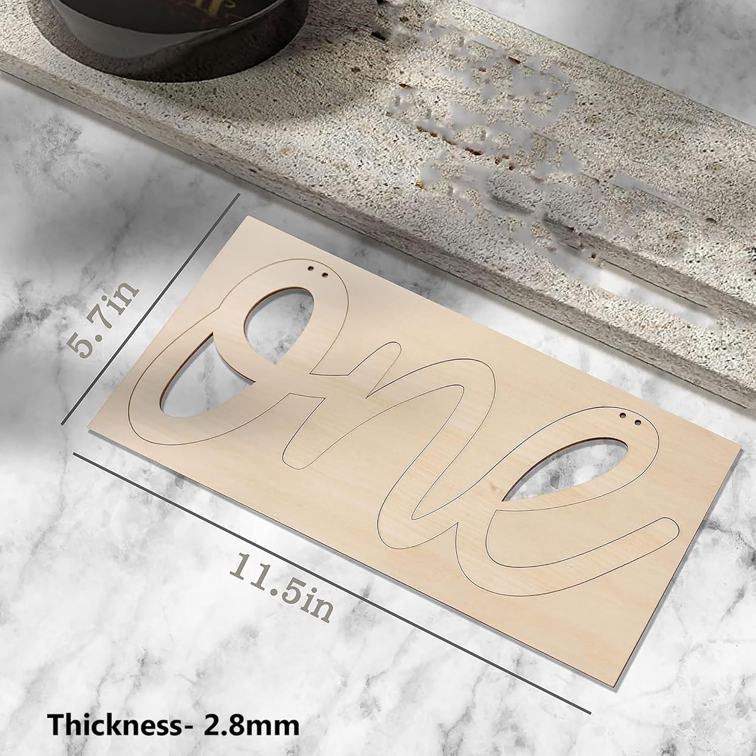 Wooden number 'One' with measurements on a marble surface