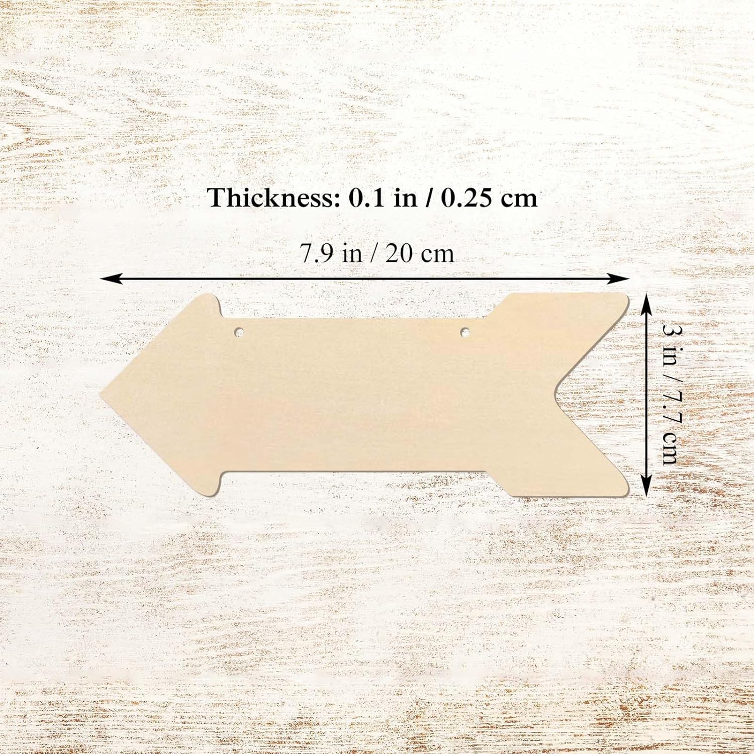 Wooden arrow-shaped cutout with measurements on a wooden surface