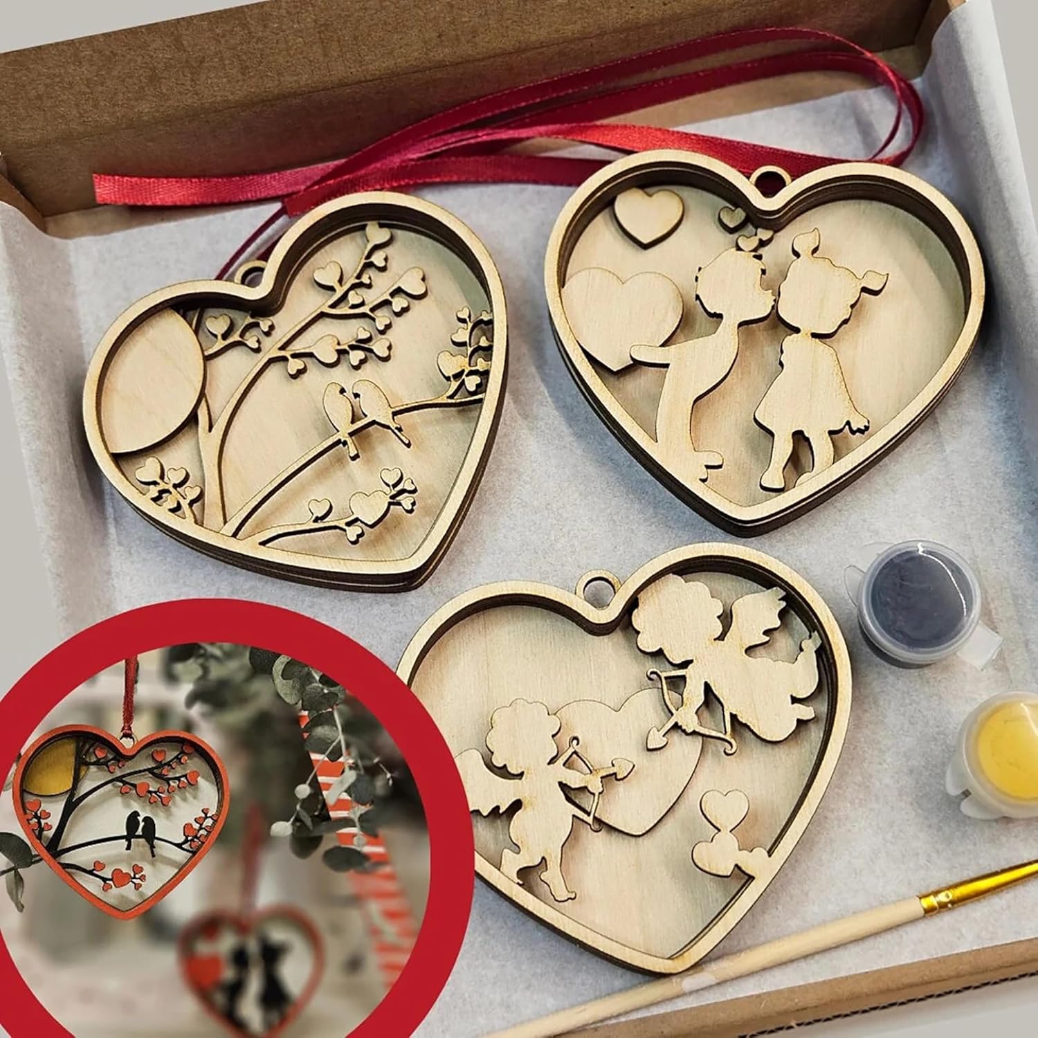 Heart-shaped wooden ornaments with paint supplies on a gray surface