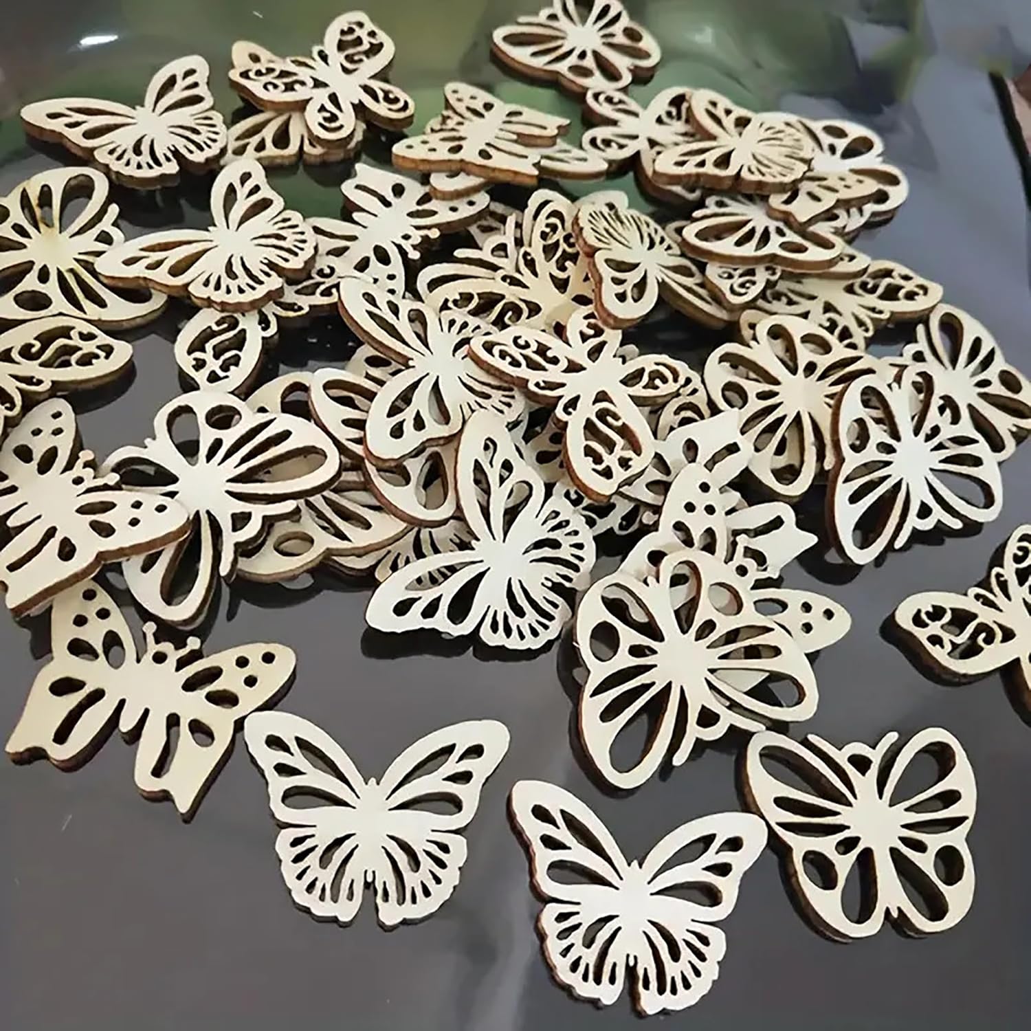Wooden butterfly shapes on a reflective surface