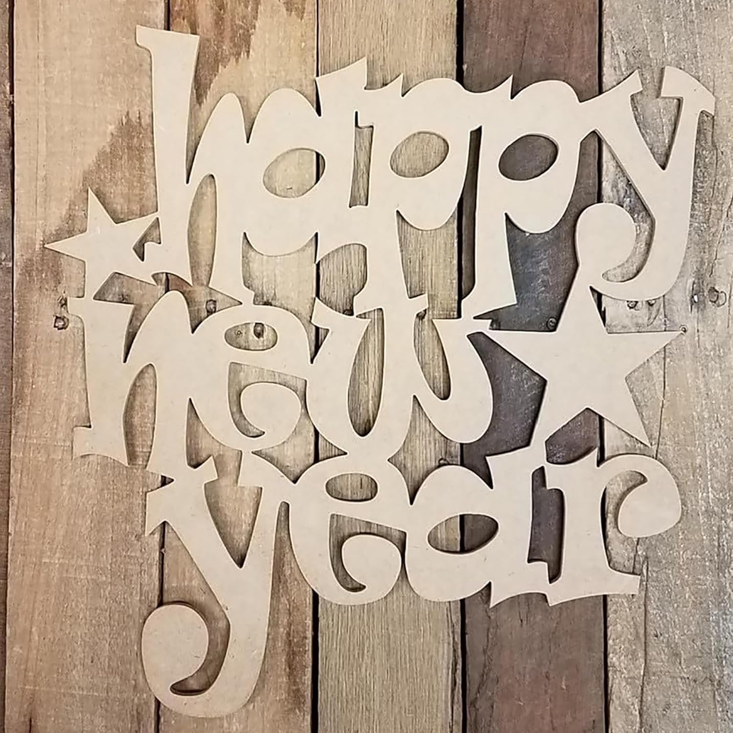 Wooden cutout with 'Happy New Year' text on a wooden background