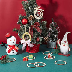 Decorative Christmas scene with small trees, ornaments, and a snowman on a red background.