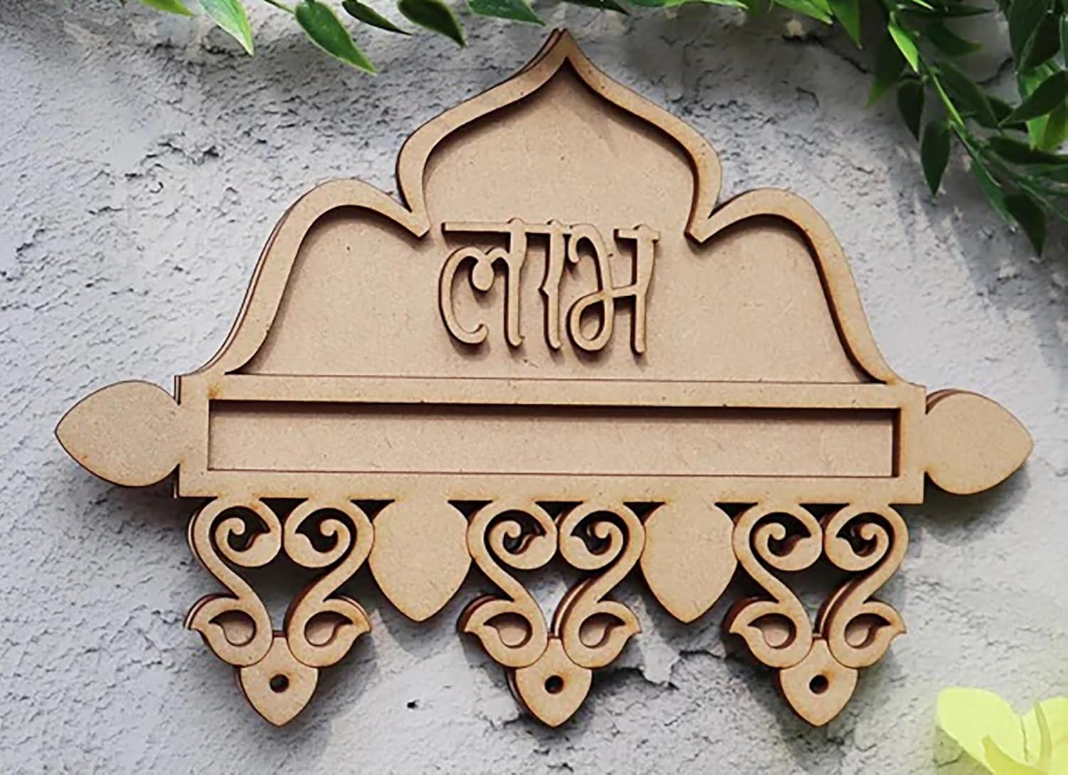 Decorative wall plaque with intricate designs and text on a light gray background