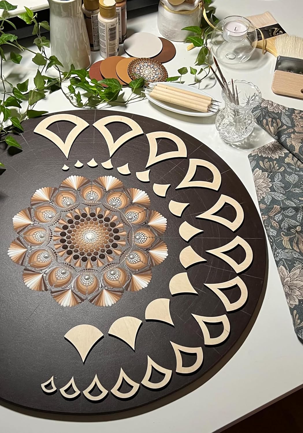 Decorative round mat with geometric design on a table with candles and plants