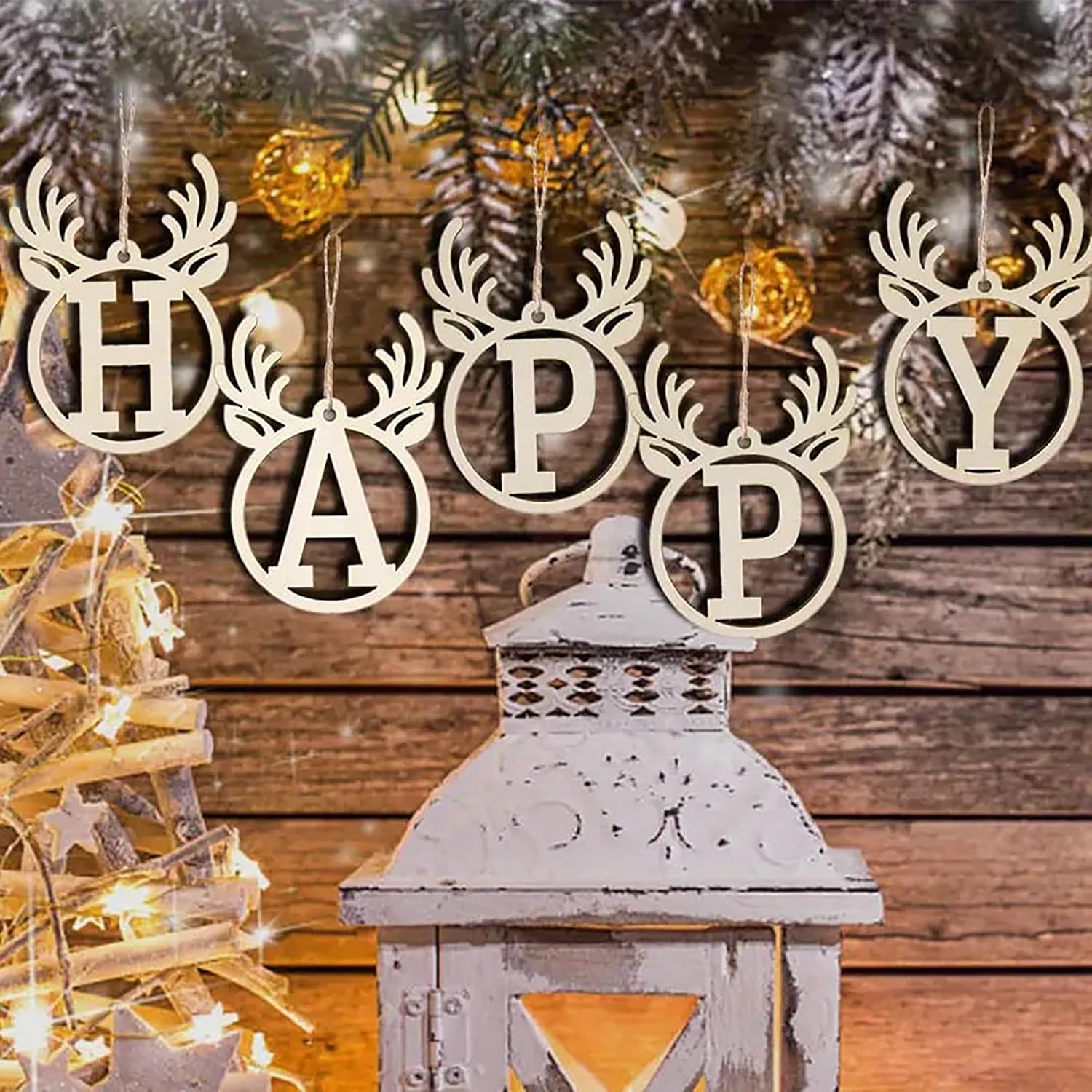 Decorative wooden letters spelling 'HAPPY' with a lantern and Christmas tree in the background.