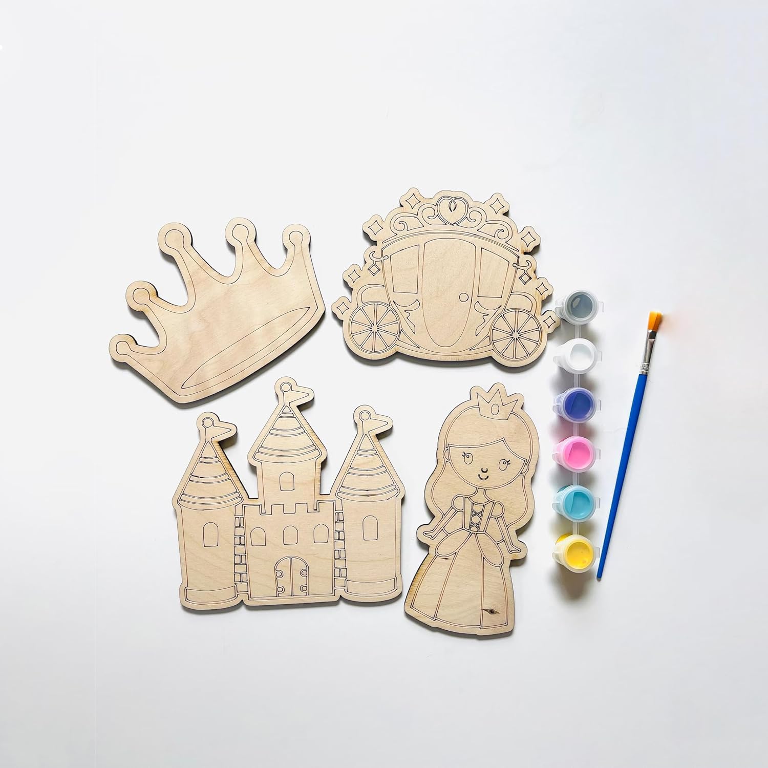 Wooden princess-themed cutouts with paint supplies on a white background