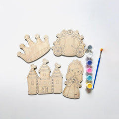 Wooden princess-themed cutouts with paint supplies on a white background