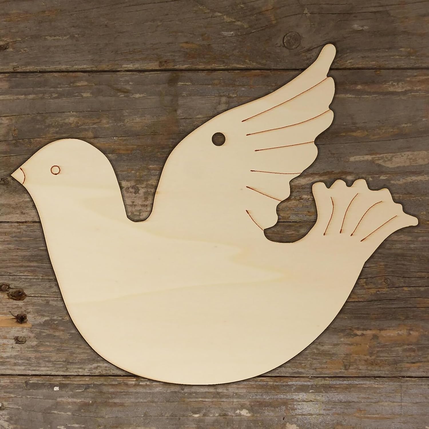 Wooden dove shape on a wooden background