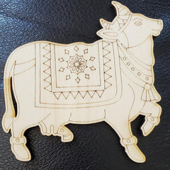 Wooden decorative cow figure with intricate patterns on a black background